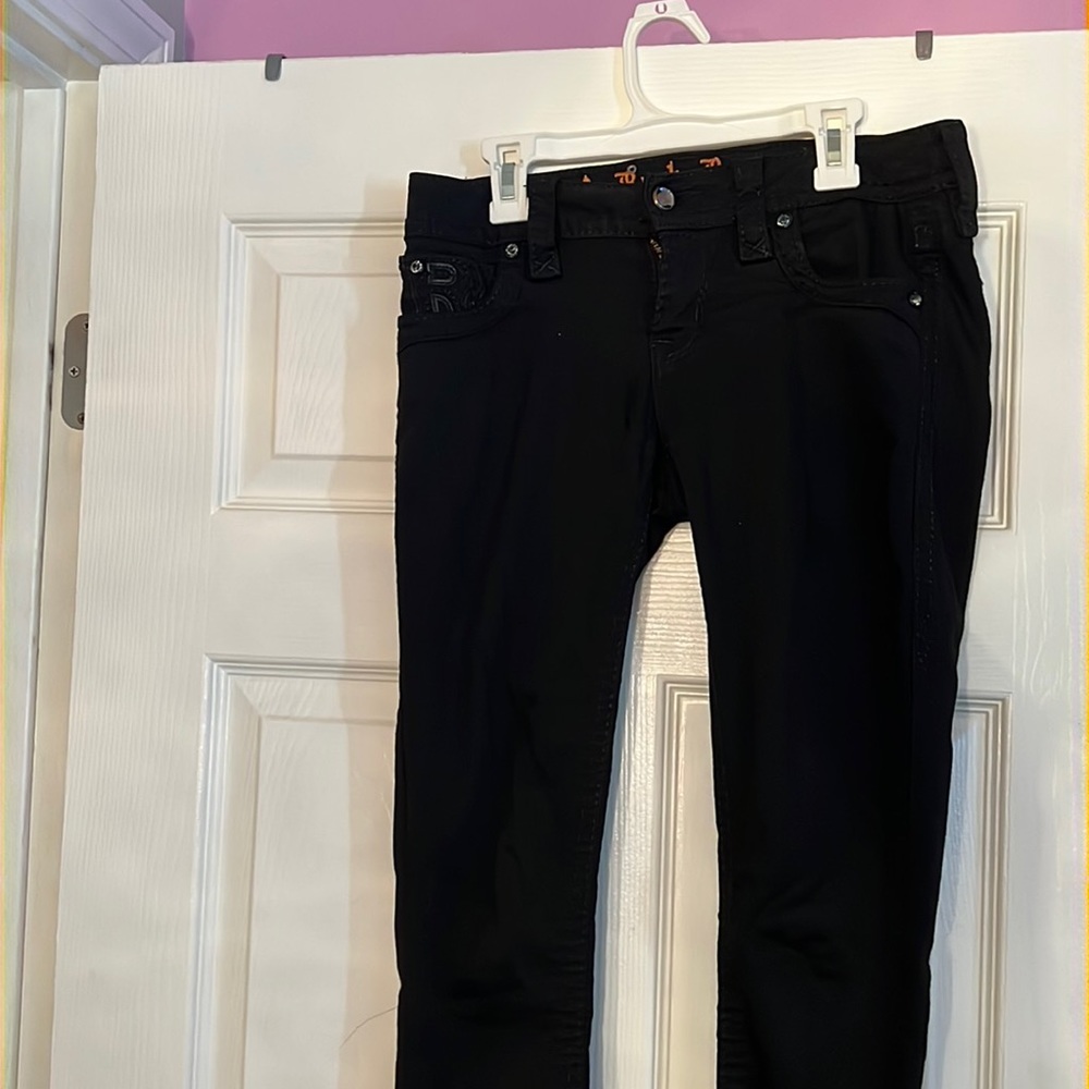 Skinny black Rock Revival jeans with studded pockets. Nice slimming fit